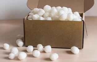 cardboard box filled with biodegradable packing peanuts from corn starch, eco-friendly filler modern shipping practices focused on reducing plastic waste , protecting fragile items during transport photo
