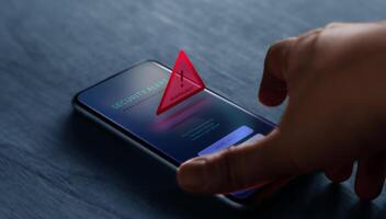 A smartphone displays a cybersecurity alert, highlighting risks of cybercrime, data breach, and digital vulnerability photo