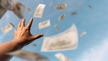 Hands reaching for money floating in the air suggest the endless pursuit of wealth, ambition, and financial opportunity in a globalized world photo