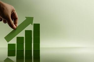 Hand placing green arrow on stacked bars, representing financial growth, rising profits, successful investment, and business recovery photo