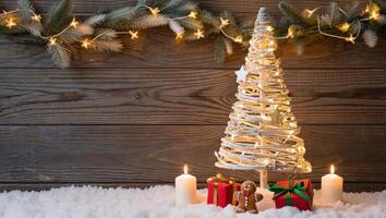 Festive Christmas Still Life with Wicker Tree Presents Candles Gingerbread Man and Snowy Background photo