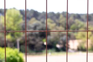 A view of a fence with a view of a field photo