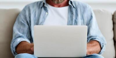 Man Using Laptop Computer on Beige Sofa Casual Home Setting photo