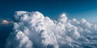 Aerial View of Cumulus Clouds at Night with Moon and Stars photo