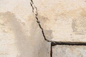 Crack formation in concrete slab urban area close-up structural integrity damage assessment photo