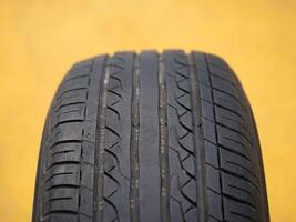 Examining tire tread patterns automotive workshop close-up image industrial environment detailed view vehicle safety insights photo