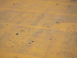 Yellow concrete surface patterns urban environment artistic close-up industrial area top-down perspective abstract concept photo