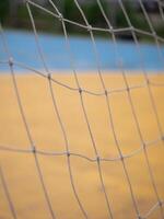Sports action close-up of a net on a yellow court outdoor photography dynamic perspective athletic vibe photo
