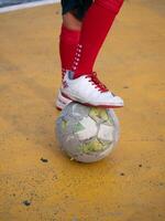 Soccer player balancing on ball urban playground sports action colorful environment dynamic viewpoint athletic skill showcase photo