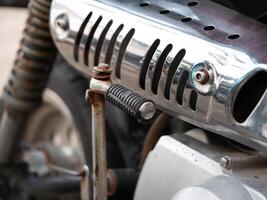 Motorcycle engine part close-up garage workshop mechanical component industrial environment macro viewpoint technical detail photo
