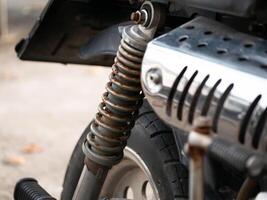Motorcycle suspension system close-up urban setting technical photography industrial environment detailed view engineering concept photo