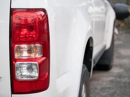 Vehicle close-up urban environment image of car tail light modern design detail orientation automotive concept photo