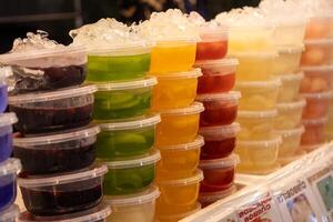 Vibrant gelatin desserts display local market food photography colorful environment eye-level view culinary art for taste enthusiasts photo
