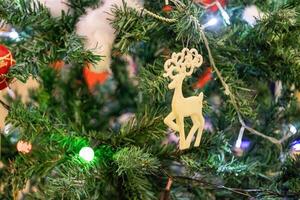 Festive christmas tree decoration featuring reindeer ornament cozy living room holiday content warm environment close-up view celebration concept photo