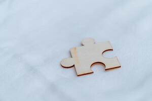 Solving business challenges a single puzzle piece on white background abstract concept minimalistic setting close-up view photo