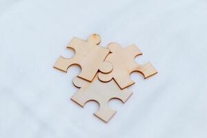 Business puzzle solving event creative workspace wooden pieces collaborative environment close-up viewpoint team dynamics photo