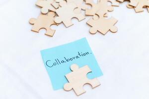 Enhancing business collaboration puzzle pieces on blue note office setting educational content professional environment close-up view teamwork concept photo