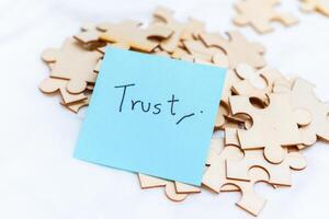 Building business trust analyzing puzzle pieces of confidence in corporate environment photo