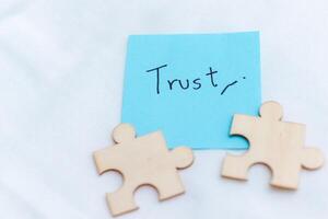 Building business trust puzzle pieces of partnership office space visual concept minimalist setting close-up view for effective collaboration photo