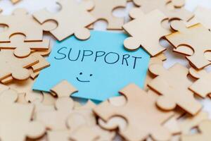 Boosting business support with puzzle pieces office setting visual content bright environment close-up collaboration concept photo