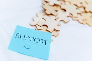 Business support puzzle pieces office desk digital note organized environment close-up view teamwork concept photo