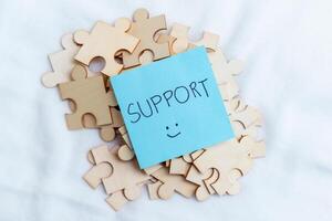 Supporting business growth puzzle pieces and collaboration workspace visual content creative environment close-up problem-solving concept photo