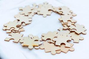 Business puzzle solving event creative collaboration in workspace wooden pieces close-up view conceptual thinking photo