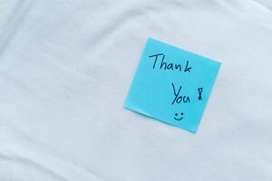 Gratitude in business thank you note on white fabric close-up inspirational calm environment personal touch photo
