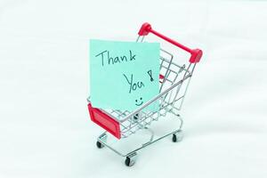 Thank you note in mini shopping cart business environment product display minimalist viewpoint gratitude concept for engagement photo