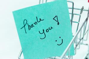 Thank you note in shopping cart business appreciation digital content minimalist environment close-up view gratitude concept photo
