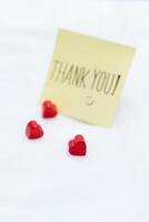 Gratitude in business thank you note with hearts on a table warm workspace close-up perspective emotional connection for seo impact photo