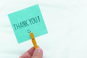 Thank you message in business context office setting note card minimalist design close-up view appreciation concept photo