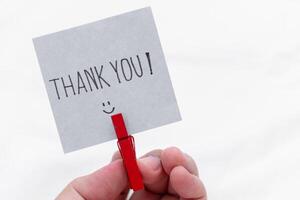 Thank you gesture personal interaction signage minimalist environment close-up view business appreciation concept photo