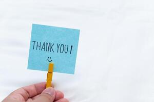 Thank you gesture business setting note card minimalist environment close-up view gratitude concept for business relationships photo