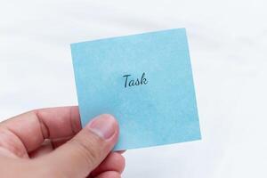 Minimalist task note in hand a calm approach to personal organization and productivity photo