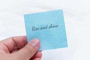 Morning motivation note inspirational setting text in hand uplifting environment close-up viewpoint positive concept photo