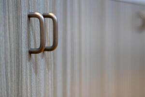 Artistic close-up of modern minimalist cabinet handle for functional interior design photo