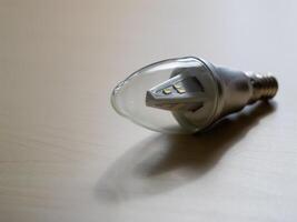Modern led light bulb on minimalist surface indoor home product photography photo