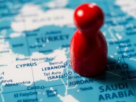 Exploring geopolitical landscapes a red marker on a map of the middle east photo