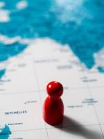 Exploring the world red marker on map global travel adventure close-up travel concept photo