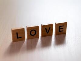 Love expression through wooden letters indoor setting minimalist style close-up view emotion concept photo