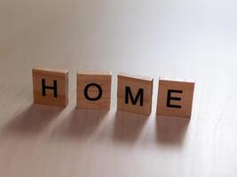 Home message in wooden blocks indoor setting still life minimalism close-up concept of comfort photo