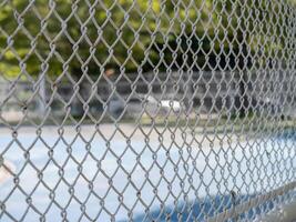 Close-up highlights of local basketball action behind the chain-link fence photo