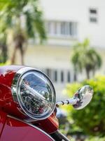 Vibrant red scooter close-up urban park sunny day focused view transportation concept photo