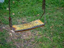 Swing set in abandoned park outdoor playground nostalgic environment close-up view photo
