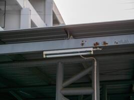Illuminating structures industrial lighting installation under steel framework urban setting photo