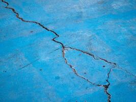 Cracked blue surface urban setting close-up industrial environment ground level texture analysis photo