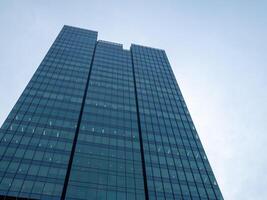 Contemporary skyscraper design in urban landscapes a low angle architectural perspective photo