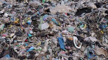 A vast landfill site is filled with mixed waste, showcasing the extent of pollution caused by plastic debris and garbage accumulation video