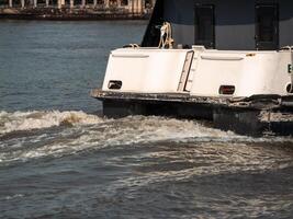 Tugboat maneuvering in daylight a close-up of maritime navigation in a harbor photo